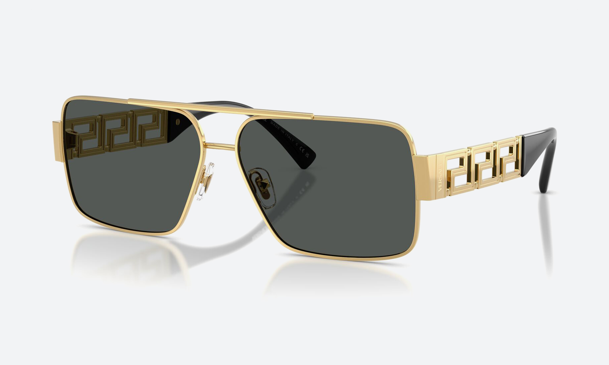 Man wearing bold Versace sunglasses in side profile